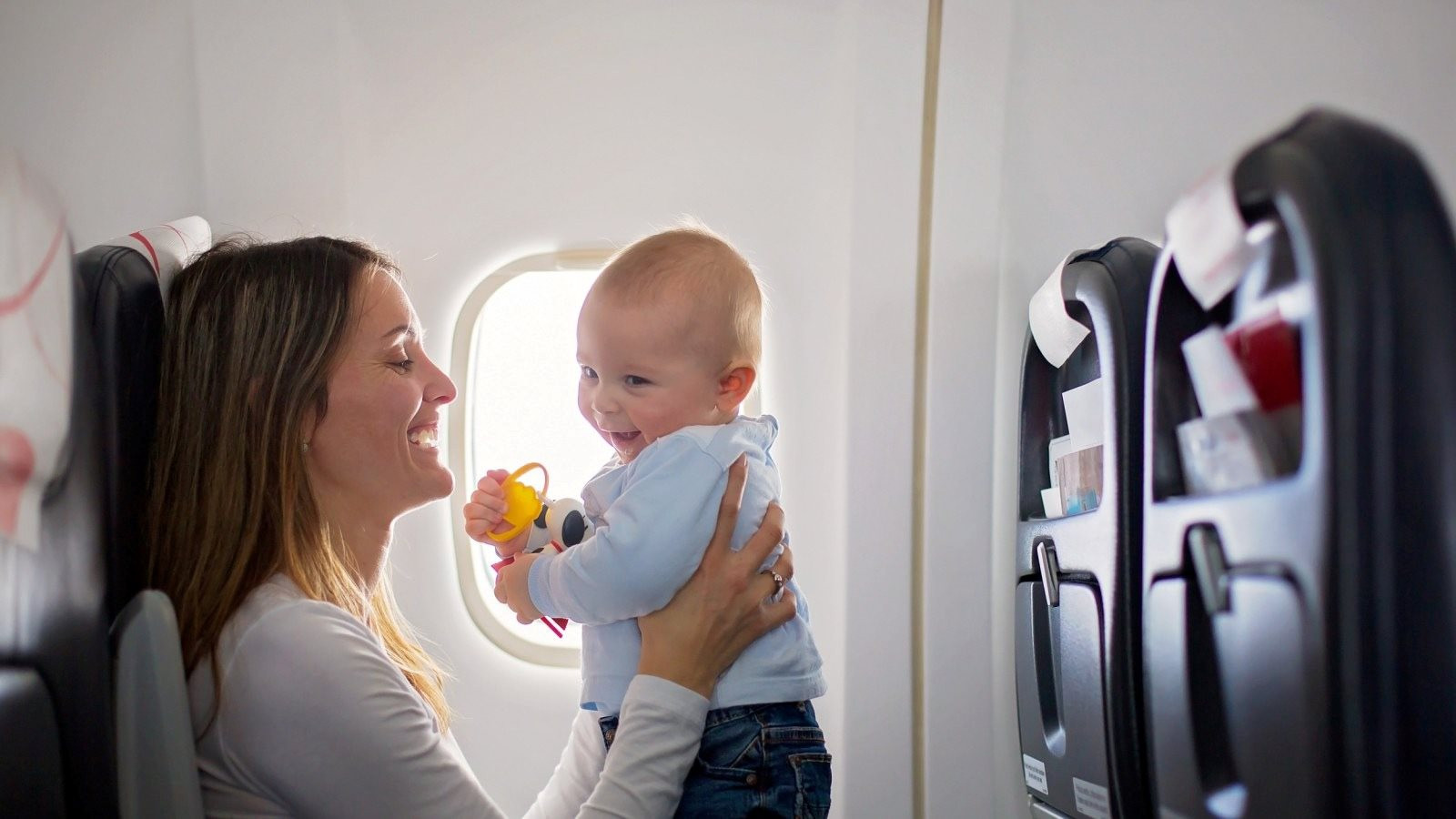 woman-holding-baby-plane.jpg