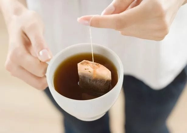 0_woman-steeping-tea-bag-in-cup-close-up-elevated-view.jpeg