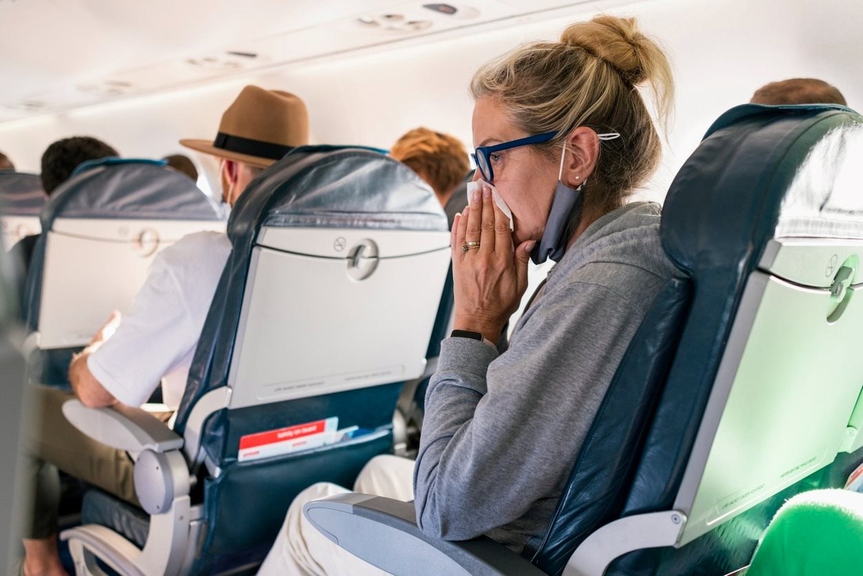 woman-blows-nose-on-plane.jpg