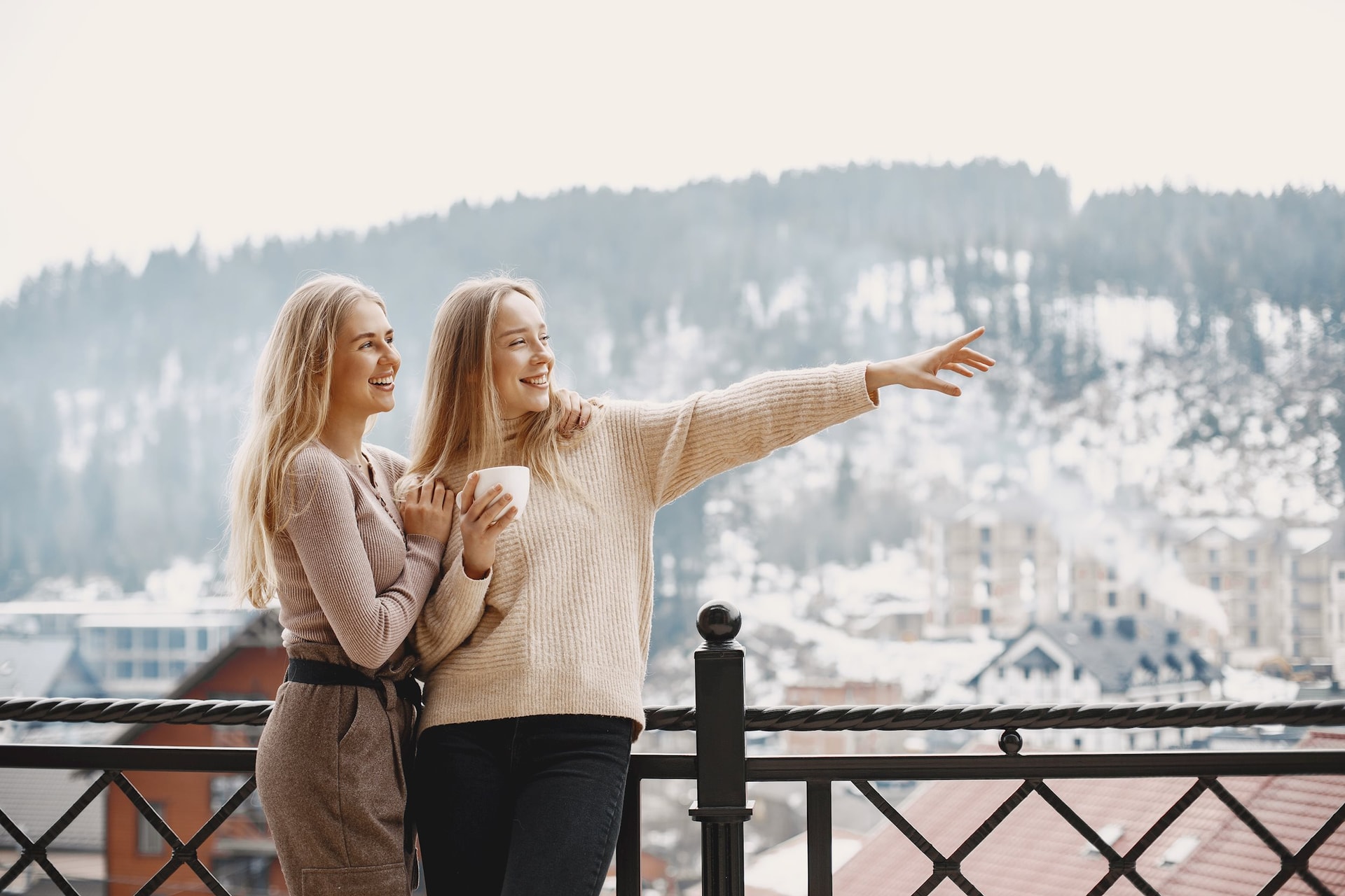 girls-light-clothes-winter-coffee-balcony-happy-women-together.jpg