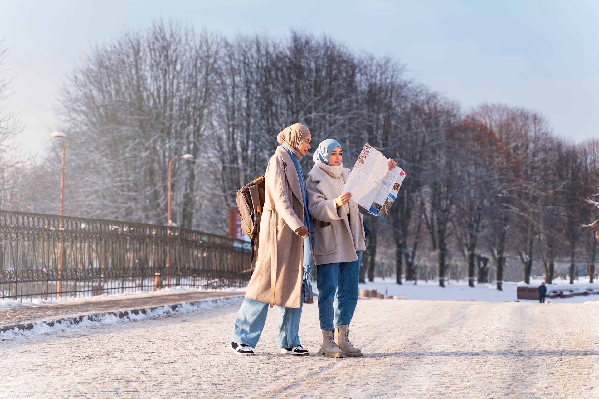 two-muslim-female-friends-consulting-map-while-traveling-city.jpg