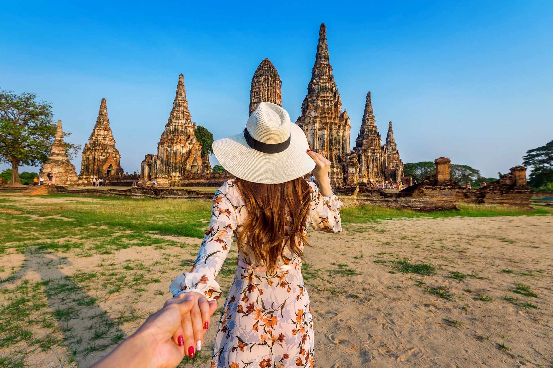 woman-holding-man-s-hand-leading-him-ayutthaya-historical-park-wat-chaiwatthanaram-buddhist-temple-thailand (1)