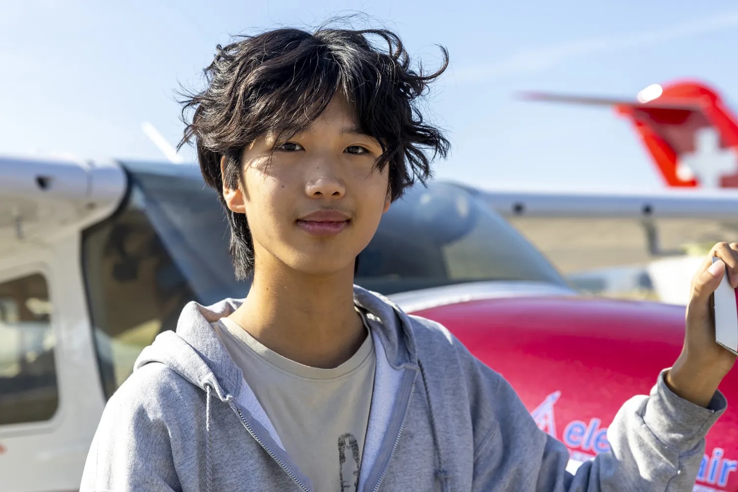 US pilot Ethan Guo poses for the photographer next to his Cessna before his take off at Geneve Aeroport for attempting a world record for a solo flight around the world, in Geneva, Switzerland, 06 August 2024