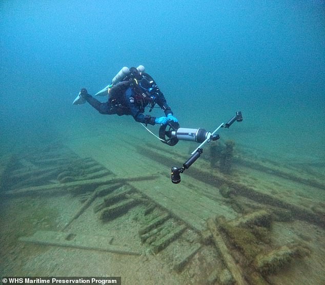 The triangle was given its name after Jay Gouley called it The Great Lakes Triangle in a book, and it picked up fame in the 1990s by Chicago Ghost Hunter, Richard Crowe, Wisconsin Historian Brendon Baillod said (pictured: diver looking at shipwreck)