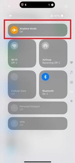 Turning on airplane mode using the iOS Control Center on an iPhone.