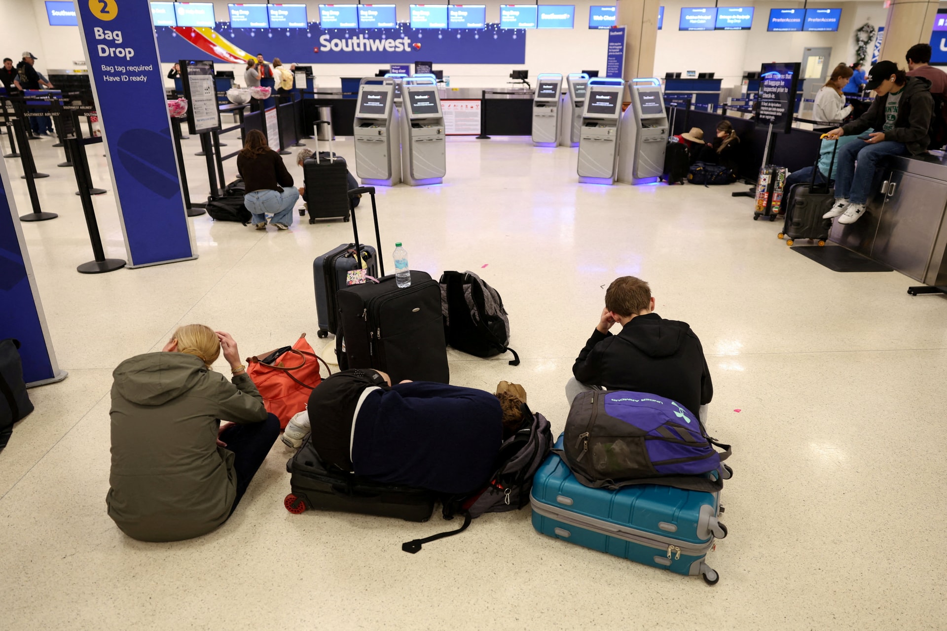 Passengers wait for flights at Luis Munoz Marin International Airport in Carolina, near San Juan, Puerto Rico after a flight ban in the Caribbean following a U.S. strike on Venezuela.