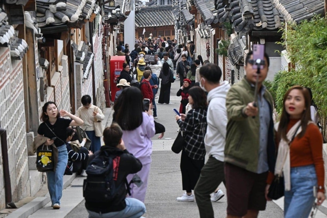A bustling alleyway filled with Chinese tourists in Bukchon Hanok Village in central Seoul
