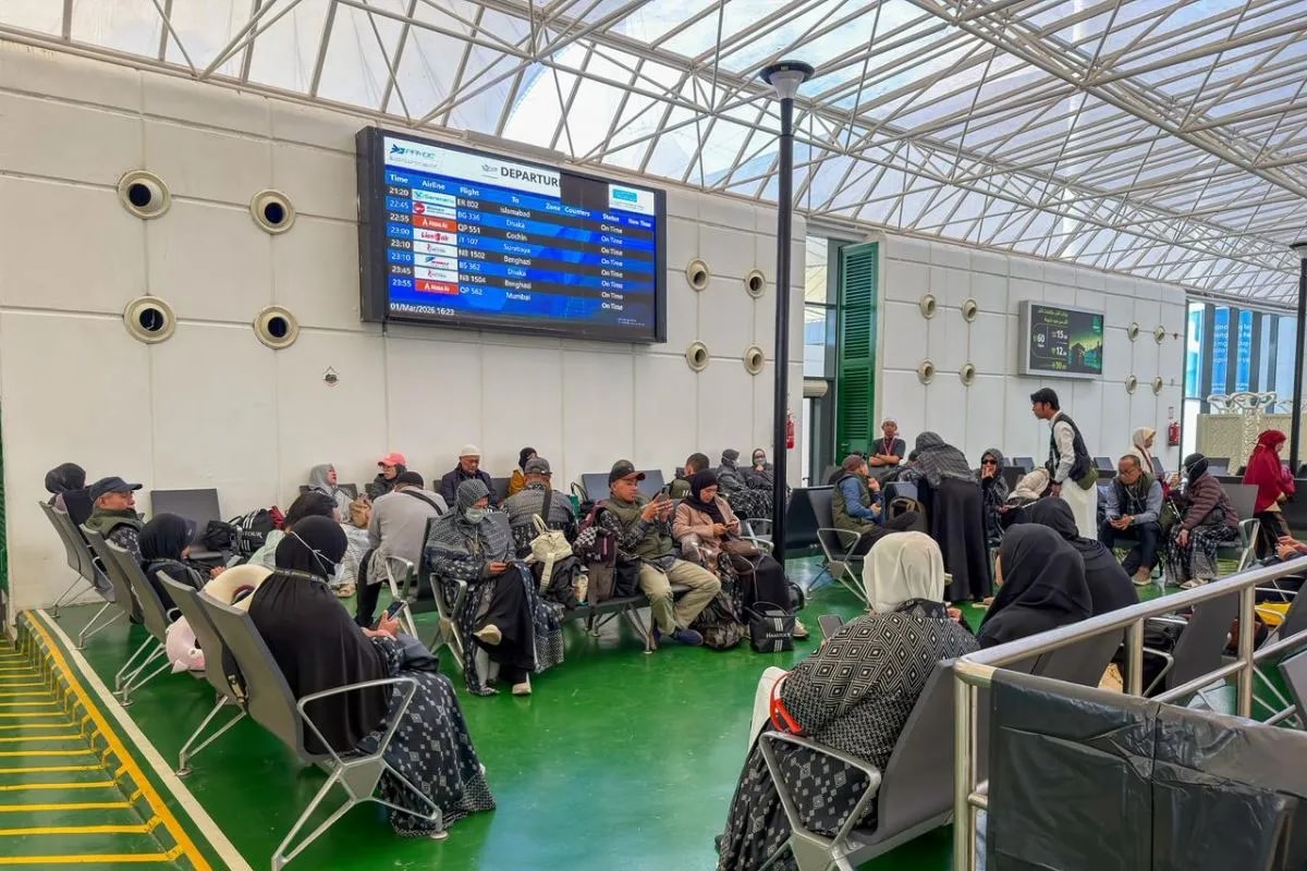 Umrah pilgrims await their return flights to Indonesia at an airport in Saudi Arabia